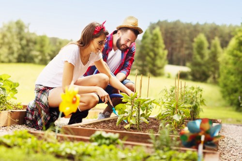 Gardeners working on a well-kept Gospel Oak garden in a local neighbourhood setting